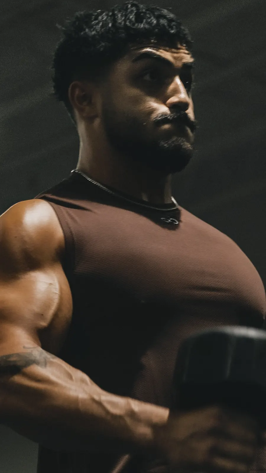 Athlete mid-lift in a brown tank
